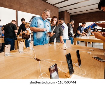 STRASBOURG, FRANCE - SEP 21, 2018: Couple in Apple Store admiring the new latest iPhone Xs and Xs Max preorder for Xr and Watch Series 4 wearable