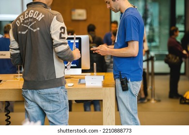 Strasbourg, France - Sept 19, 2014: Apple Store With Genius Worker Employee Scanning Box Barcode Of New Latest IPhone Smartphone During Sale Starts For Customers In Oregon Jacket