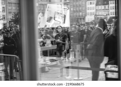 STRASBOURG, FRANCE - SEPTEMBER 19, 2014: Apple Store Interior Reflected With Female Genius Worker And Customers Waiting In Line Outside In Front The Store During The Sales Launch Of The IPhone X 8