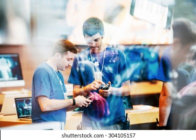 STRASBOURG, FRANCE - SEPTEMBER 19, 2014: Apple Store interior reflected with customers waiting in line outside in front the store during the sales launch of the iPhone X 8 Plus