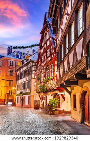 Strasbourg, France. Traditional Alsace half-timbered houses in Petite France during twilight decorated  at Christmas time.