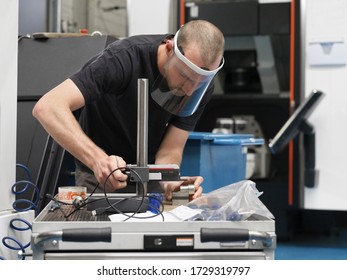 Strasbourg, Grand Est, France - May 11th 2020: Worker of a mechanical workshop working with a sanitary mask after the French quarantine period due to COVID19.