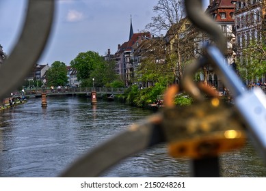 Strasbourg River And Houses Through Fence With Lock