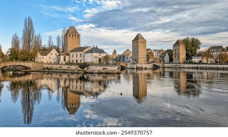 Strasbourg with the three towers and bridges over the river Ill at blue cloudy sky - Powered by Shutterstock