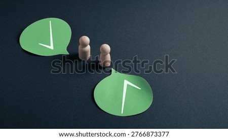 Strategic alignment and shared direction concept represented by wooden figures and speech bubbles with arrow icons pointing the same way, symbol of corporate vision, teamwork, goal orientation and business coordination.