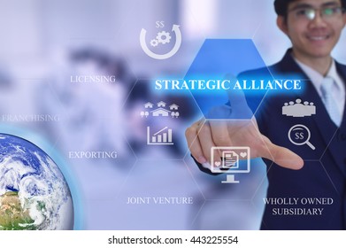 STRATEGIC ALLIANCE in entry strategy concept presented by  businessman touching on  virtual  screen -image element furnished by NASA