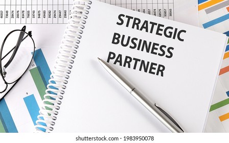 STRATEGIC BUSINESS PARTNER, Pen And Glasses On Chart, Business Concept