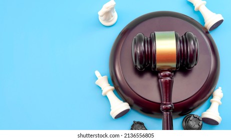 Strategic Lawsuit Settlement, Develop Legal Strategy And Planning Court Challenge Concept With Judge Gavel And Chess Pieces Isolated On Blue Background With Copy Space