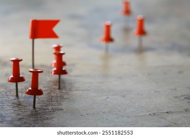 Strategic Planning with Red Push Pins and Flags on a World Map - Powered by Shutterstock