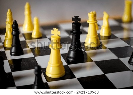 A strategic standoff unfolds on the checkered battlefield, where opposing chess pieces embody the very essence of confrontation