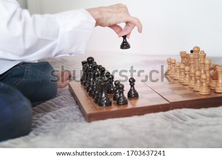 Strategy concept, hand of woman moving wooden chess figure in play, management or leadership competition business success background