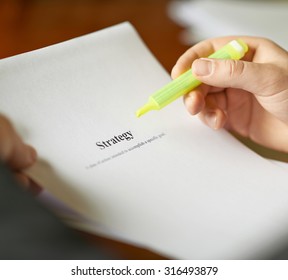 Strategy definition as a shallow depth of field close-up composition of a man in a business suit working with the text