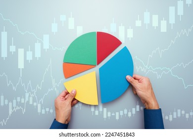 Strategy of diversified investment.  Investor managing portfolio. Pie chart and candlestick charts. 