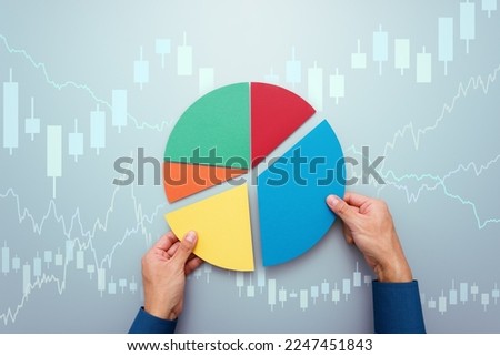 Strategy of diversified investment.  Investor managing portfolio. Pie chart and candlestick charts. 