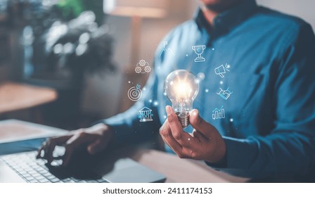 strategy, goal, success, target, aim, futuristic, marketing, performance, achievement, choose. typing at keyboard and another hand of palm hold a light bulb, trophy, strategy, target symbolic show.