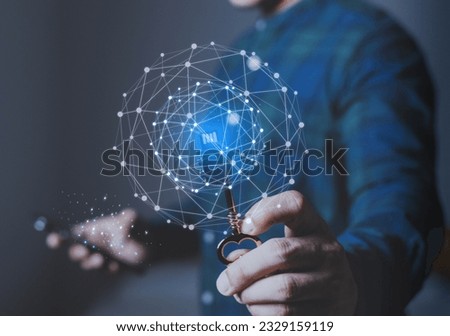 Strategy ideas  business concept. Businessman holding golden key and have futuristic graphic icon. Making a plan for success, secrete data