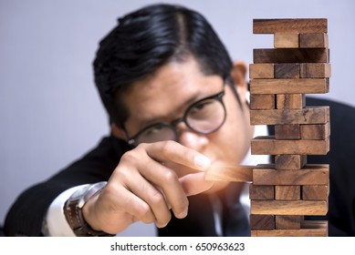 Strategy Risk Management, Strategy Concept: Young Asian Businessman With Brain Game: Jenga Game