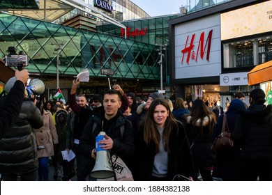 STRATFORD, LONDON, ENGLAND- 5 December 2020: Anti-lockdown Standupx protesters walking through Westfield Stratford