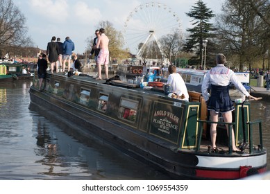 Stratford Upon Avon Warwickshire England UK April 14th 2018 Stag Party Revellers In Fancy Dress Drinking Alcohol And Driving A Boat Into The Canal Basin During A Warm Spell Of Weather 