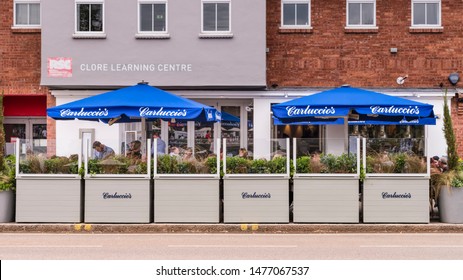 Stratford Upon Avon, Warwickshire/England UK - 08.04.2019: Cafes And Restaurants: Exterior Of Carluccio's With Outside Dining And Sunshades. 