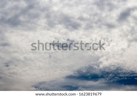 A stratocumulus cloud belongs to a genus-type of clouds characterized by large , rounded masses, usually in groups, lines, or waves, the individual elements being larger than those in altocumulus.