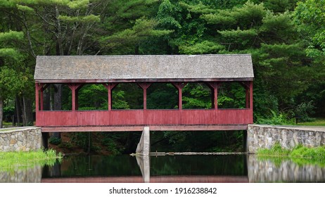 Stratton Brook State Park Simsbury Connecticut.  A Red Wooden Covered Bridge Reaches Across A Stream.