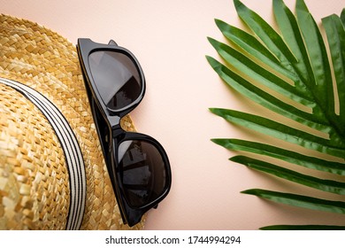 Straw Beach Hat And Sun Glasses Top View On Pink Background, Summer Flat Lay