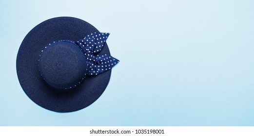 Straw Blue Beach Female Hat. Travel Or Vacation Concept. Top View Blue Background Flat Lay. Summer Background.