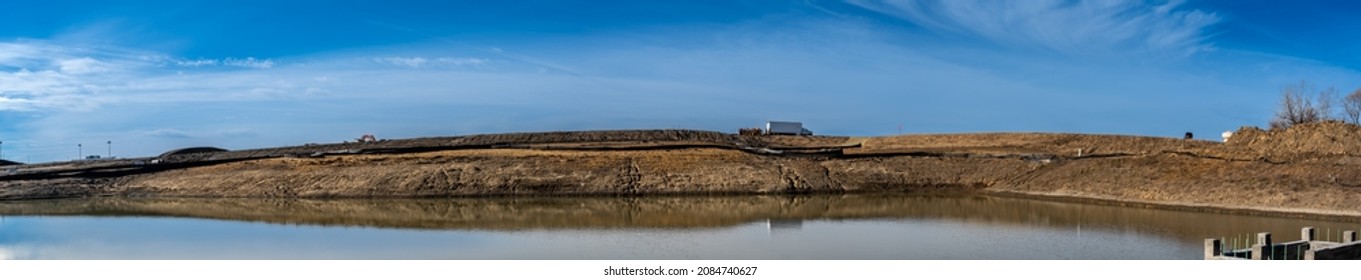 Straw Covered Slope Leading To A Stormwater Retention Basin Used To Control Soil Erosion At A Construction Site 