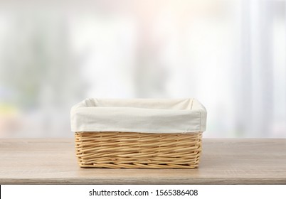 Straw empty basket decorated with white linen on wooden table,food advertisement template.Container. - Powered by Shutterstock