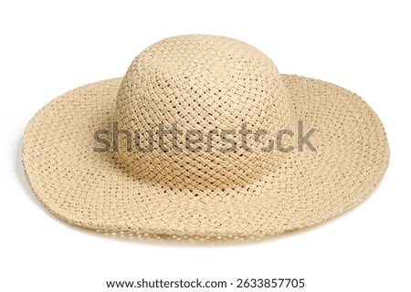 Straw hat lying at angle from above isolated white background. Beach hat front view with clipping path as design banner, studio shot with sunlight. Summer travel cap for beach holidays on Vacation