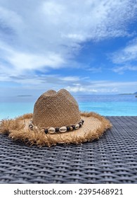 Straw hat on the beach. Beach holiday and travel concept. - Shutterstock ID 2395468921