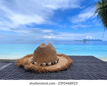 Straw hat on the beach. Beach holiday and travel concept. - Shutterstock ID 2395468923