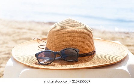 Straw hat and sunglasses on the beach. Beach holiday concept.  - Shutterstock ID 2167255509