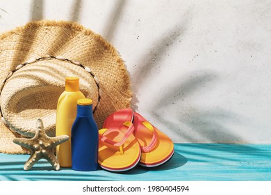 Straw Hat, Sunscreen, Beach Slippers And Starfish On The Table, Summer Background.