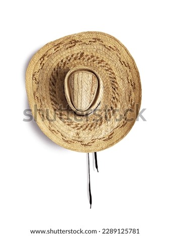 straw hat top view isolated on white background. Close up of wide brimmed straw hat from the French West Indies. Culture, fashion and Caribbean civilization.