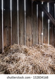 Straw in the old barn with timber wall