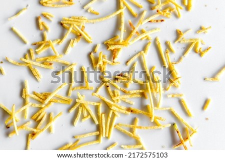 straw potato chips spread on white background.