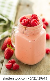 Straw- and raspberry smoothie with a tablecloth