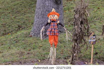 A Straw Scarecrow With His Sign Welcoming Fall.