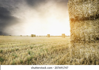 Straw Square Bale On Field With Sunset Cloudy  Sky , Nature Background