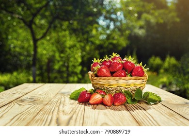 strawberries in basket on wooden table in natural background, delicious first class organic fruit as a concept of summer vitamins - Powered by Shutterstock