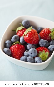 Strawberries And Blueberries On The Light Blue Cloth