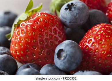 Strawberries And Blueberries On The Wood Table