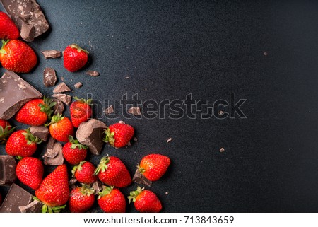 Strawberries and chocolate on a blackboard.