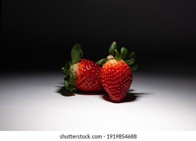 Strawberries - creative lighting - black and white background and side light