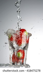 Strawberries In A Cup With Water Causing Splash