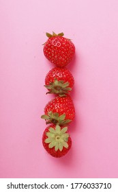 strawberries flat lay composition on a pink background