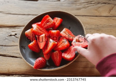  strawberries on a wooden table.Berries in a plate on a wooden table. Summer berry harvest. Healthy Sweet Dessert