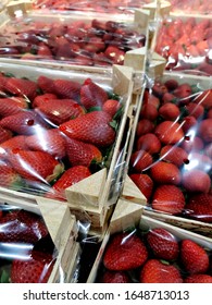 Strawberries packed in boxes with cellophane